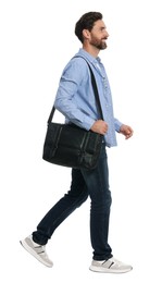 Photo of Handsome man with bag in stylish outfit walking on white background