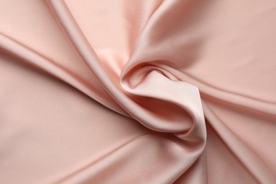 Photo of Crumpled pink silk fabric as background, top view