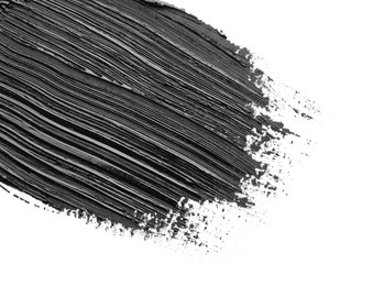 Photo of Brushstrokes of black oil paint on white background, closeup