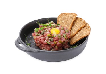 Photo of Tasty beef steak tartare served with yolk, capers and sliced bread isolated on white