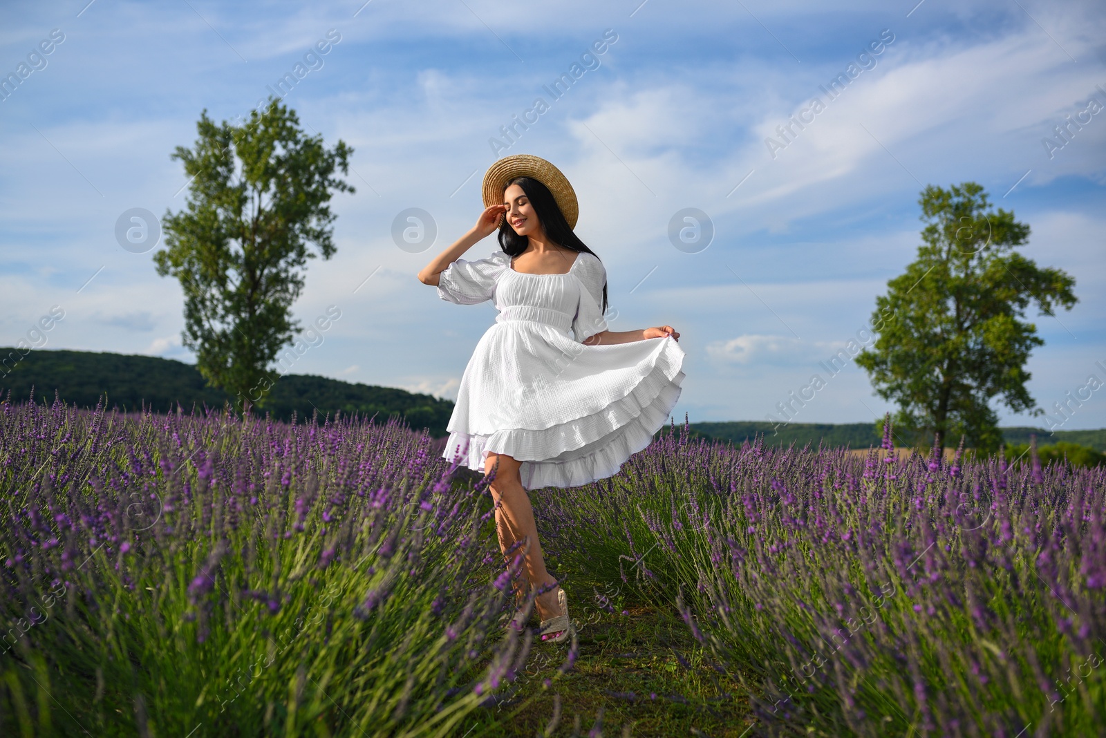 Photo of Beautiful young woman walking in lavender field