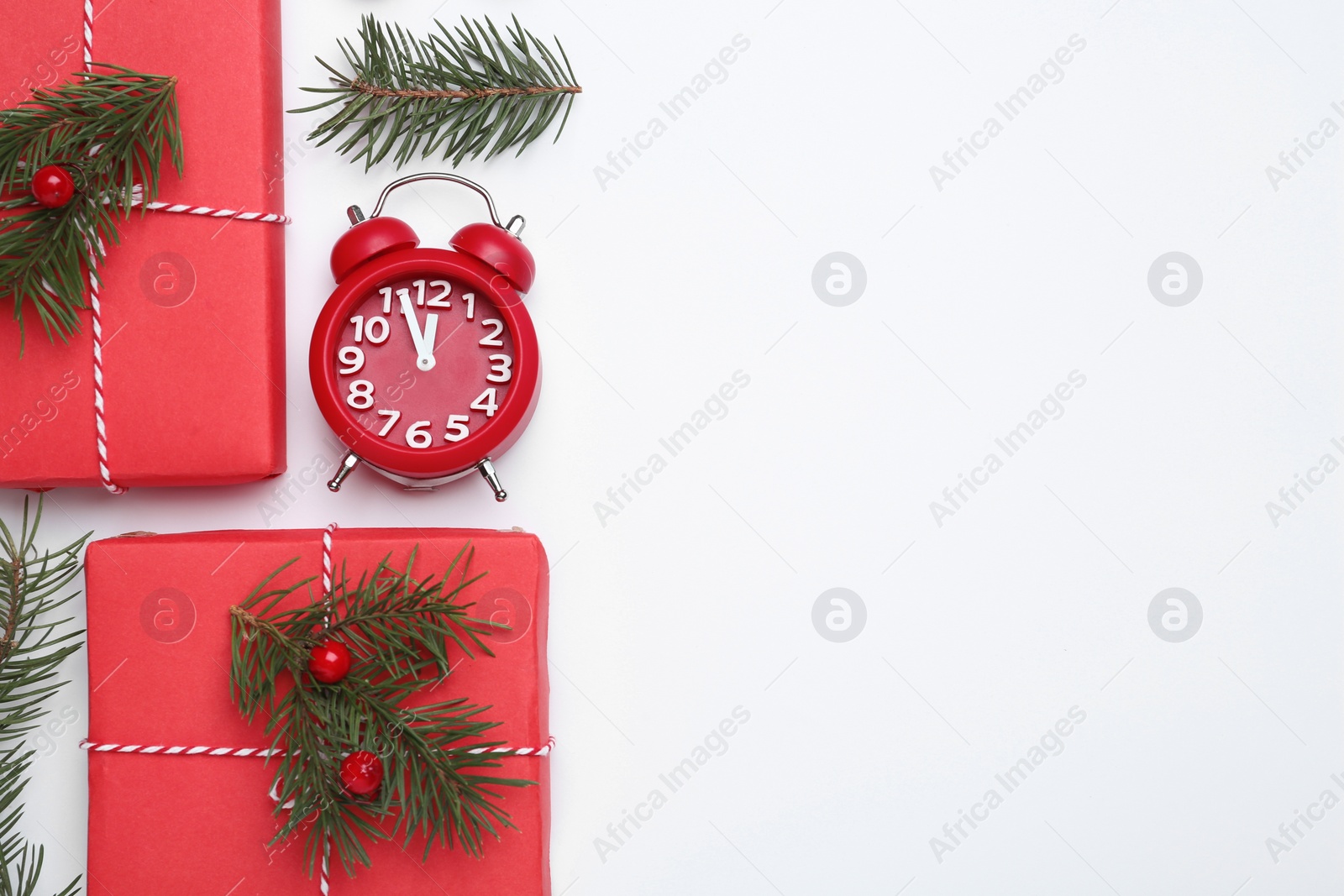 Photo of Flat lay composition with Christmas gift and alarm clock on white background, space for text. Boxing day