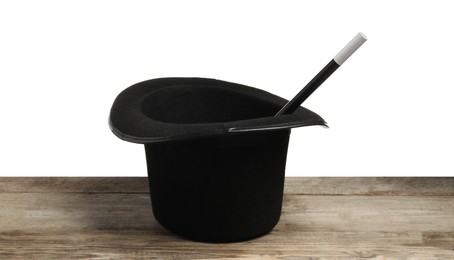 Photo of Magician's hat and wand on wooden table against white background