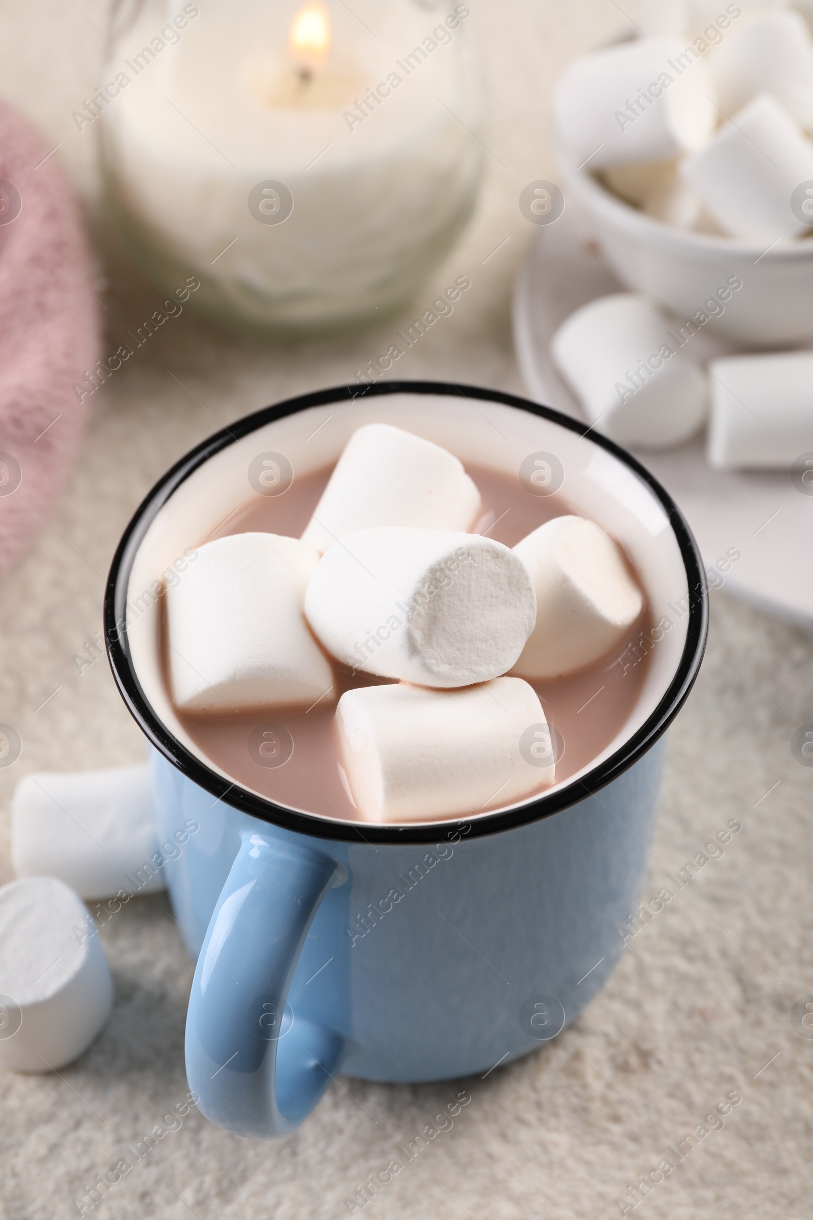 Photo of Cup of aromatic hot chocolate with marshmallows served on table, closeup