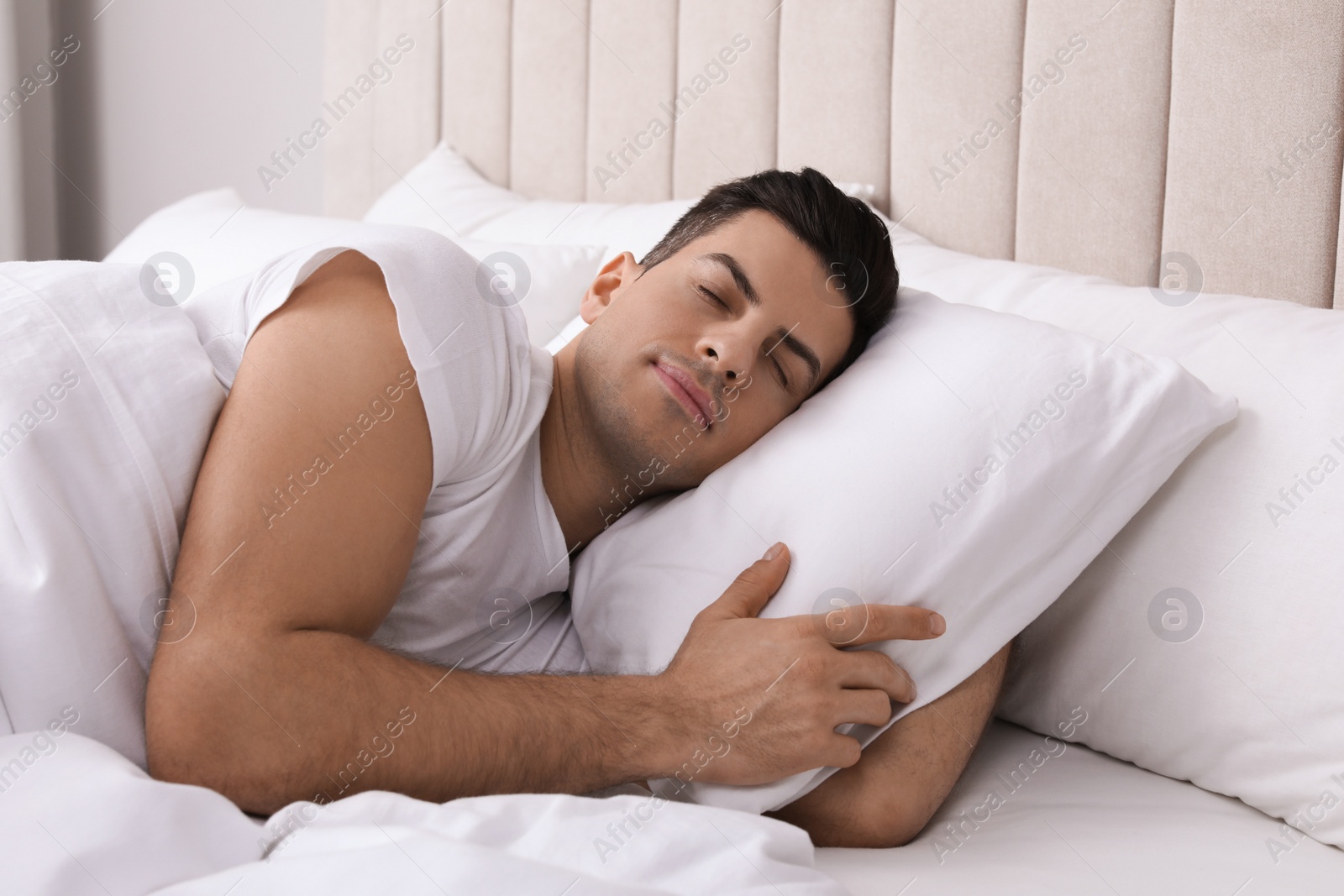 Photo of Handsome man sleeping in bed at home