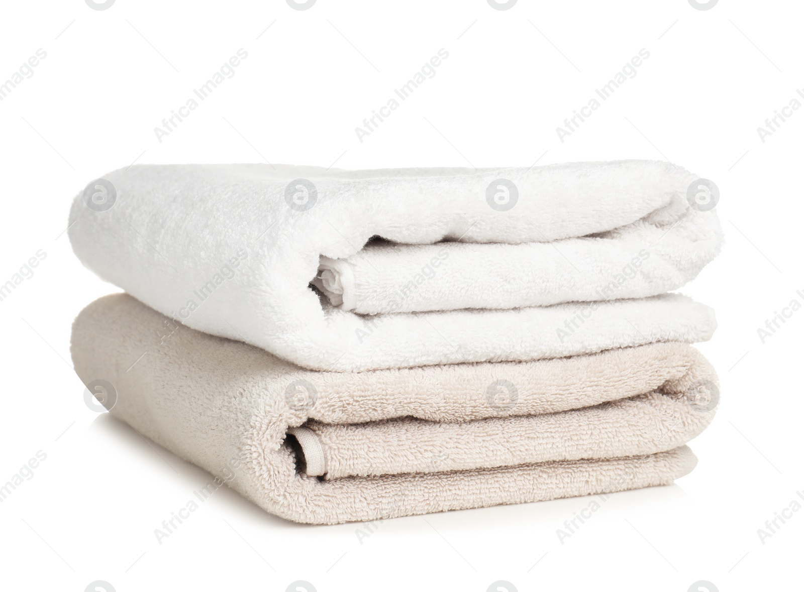 Photo of Folded soft terry towels on white background