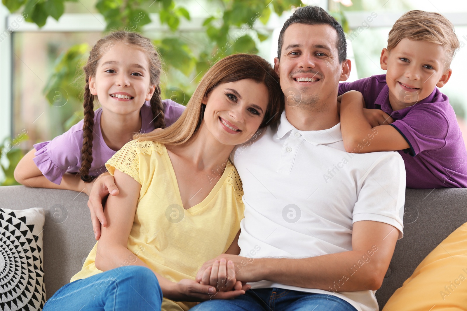 Photo of Happy family with cute children at home