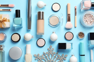 Photo of Flat lay composition with makeup products and Christmas decor on color background