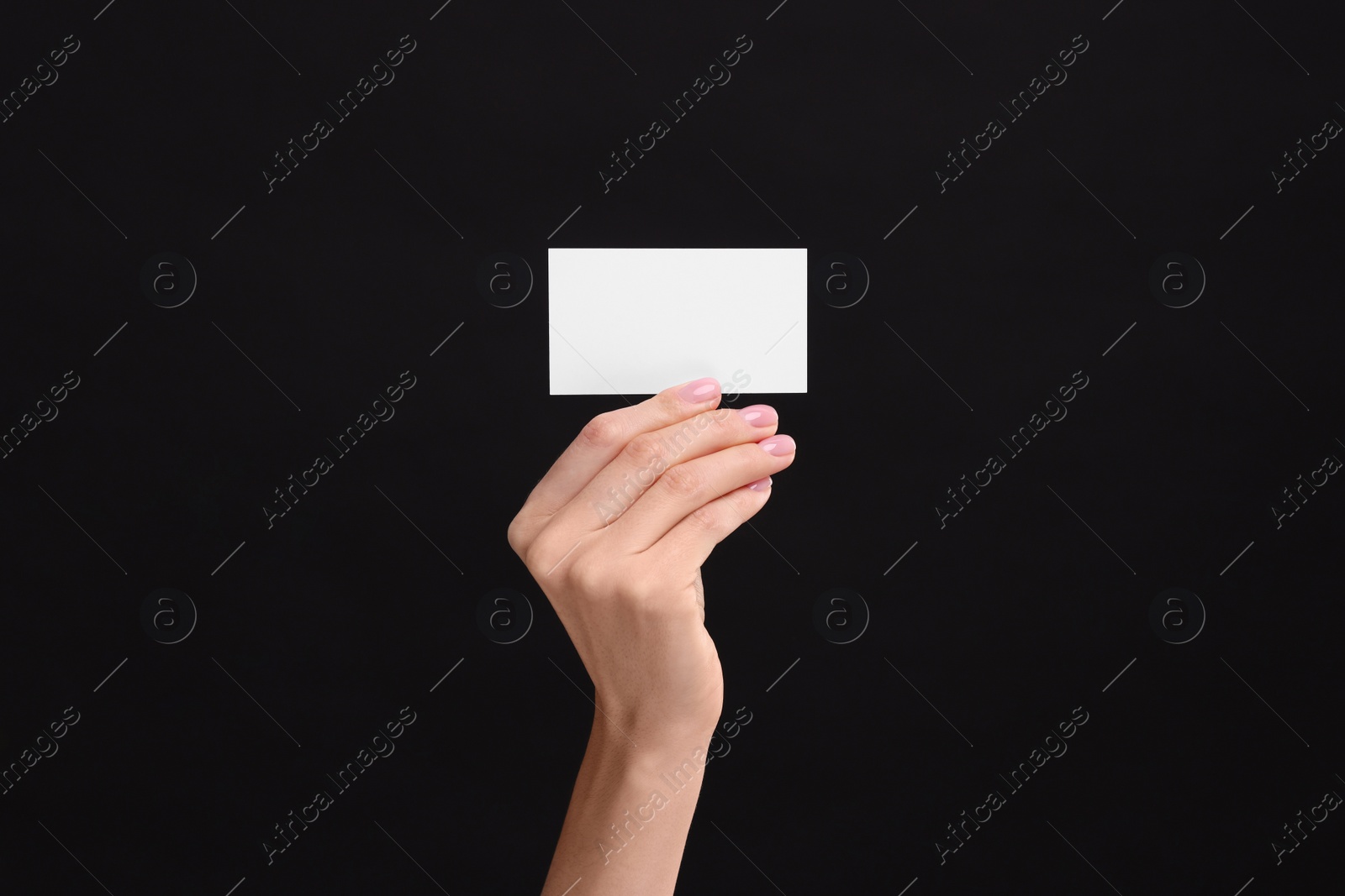 Photo of Woman holding blank business card on black background, closeup. Space for text