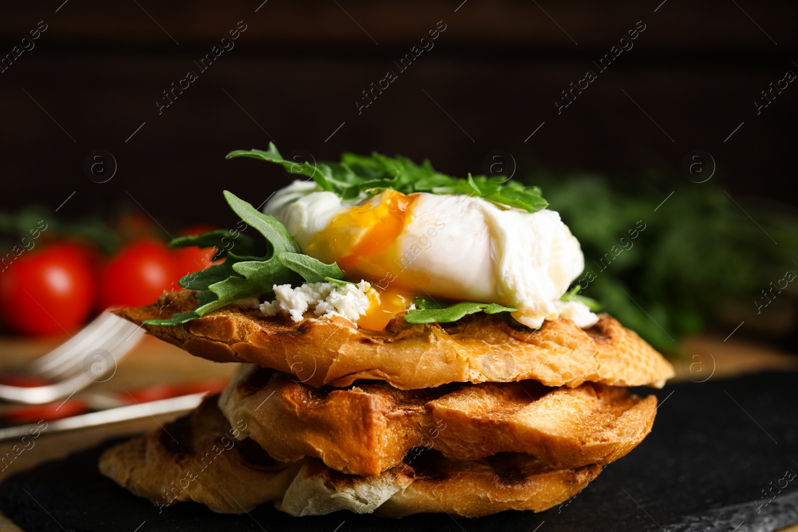 Photo of Delicious sandwich with arugula and egg on slate board, closeup