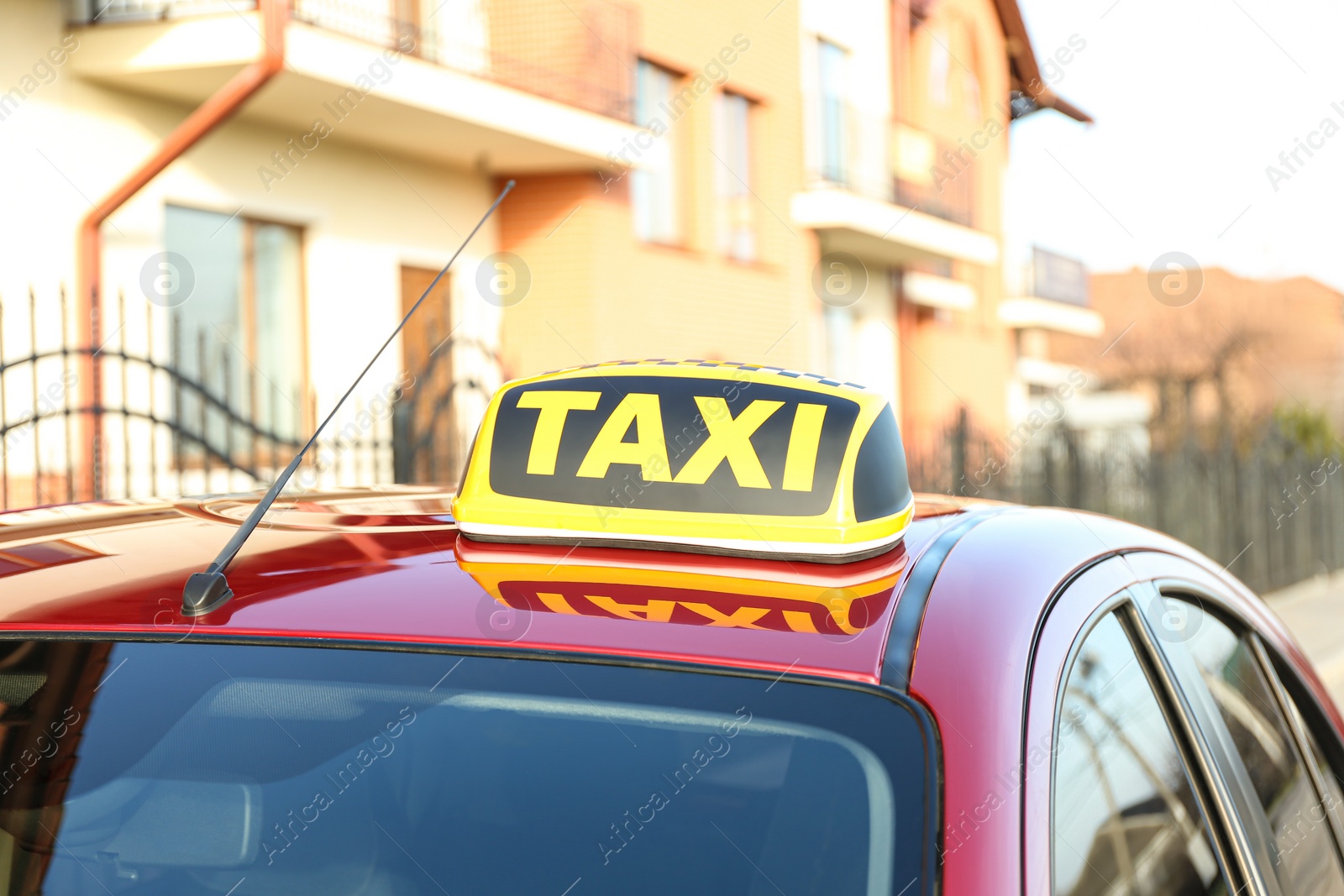 Photo of Roof light with word TAXI on car outdoors