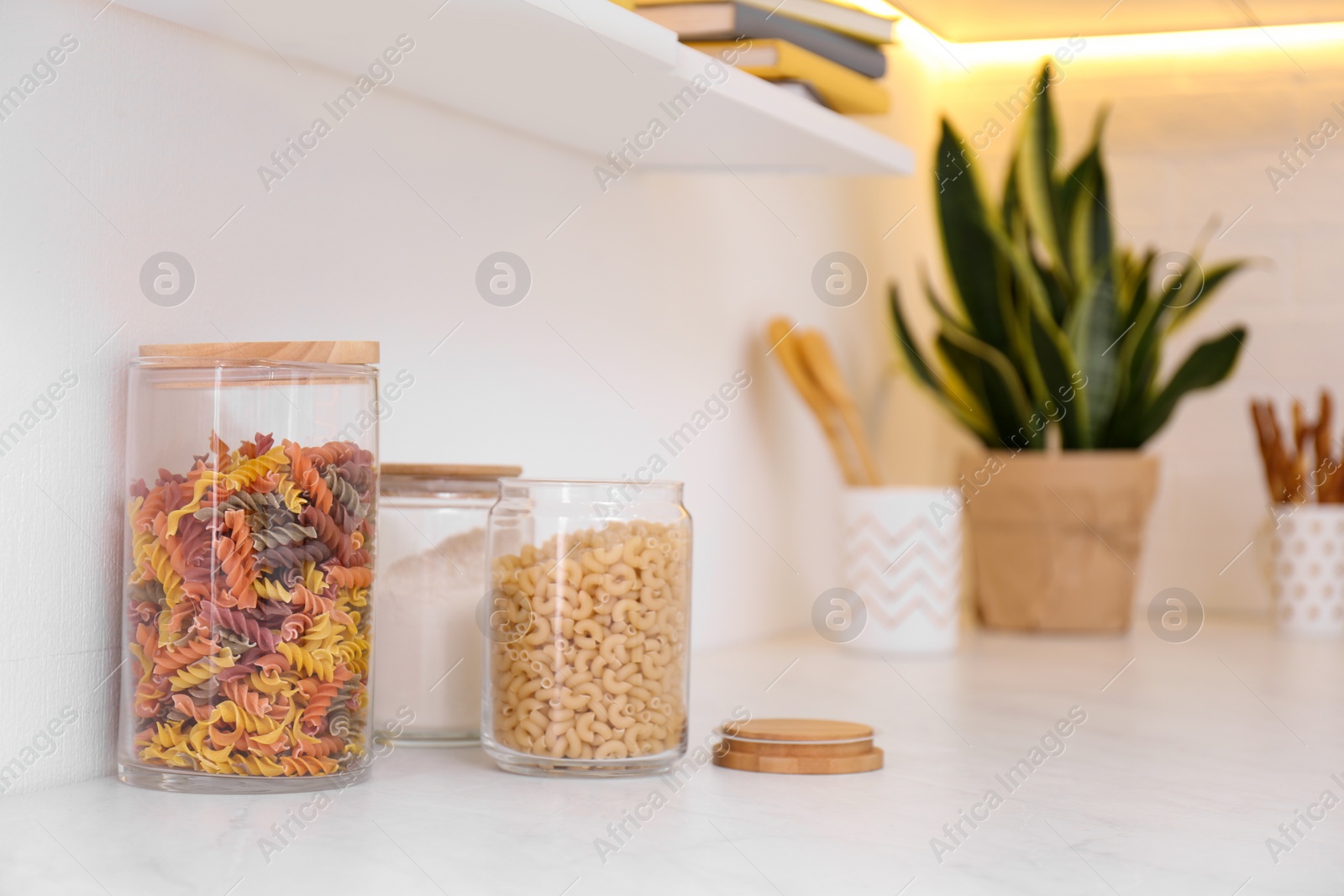 Photo of Different types of pasta on counter in modern kitchen