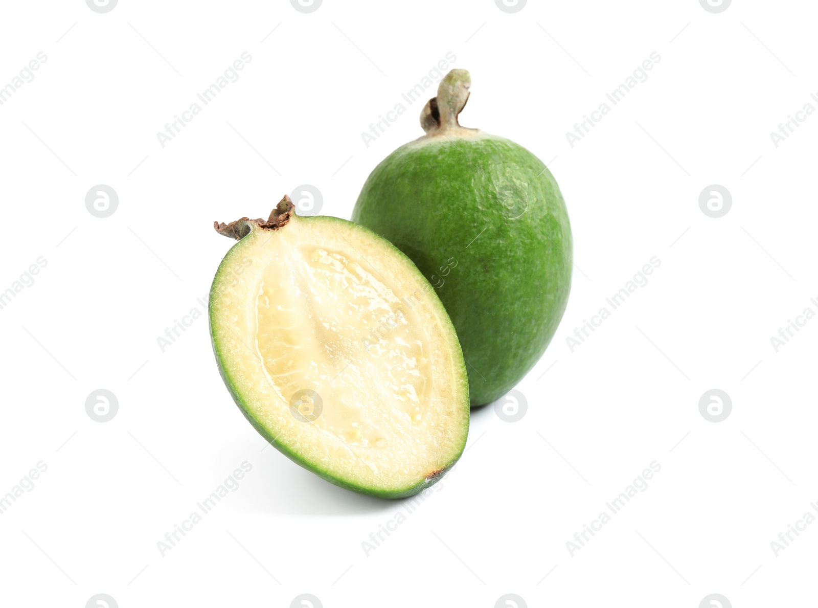 Photo of Cut and whole feijoas on white background