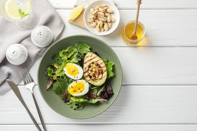 Photo of Healthy dish high in vegetable fats served on white wooden table, flat lay. Space for text