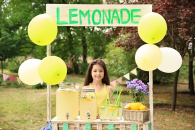 Photo of Little girl at lemonade stand in park