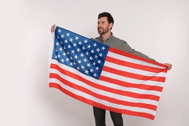 4th of July - Independence Day of USA. Happy man with American flag on white background