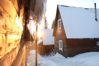 Wooden houses covered with snow. Winter vacation