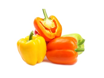 Whole and cut bell peppers on white background