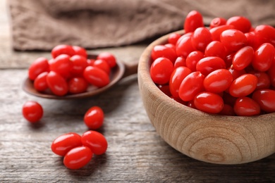 Photo of Fresh ripe goji berries on wooden table, closeup