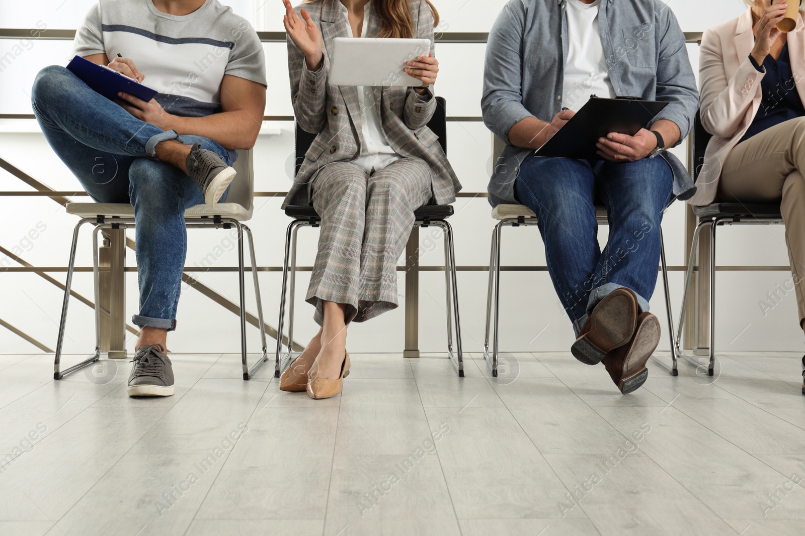 Photo of People waiting for job interview in office, closeup