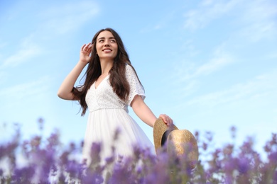 Photo of Young woman with straw hat in lavender field