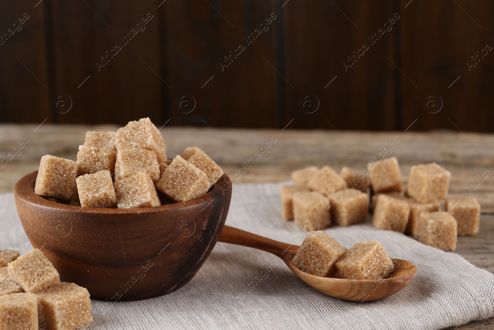 Photo of Many brown sugar cubes on table, closeup