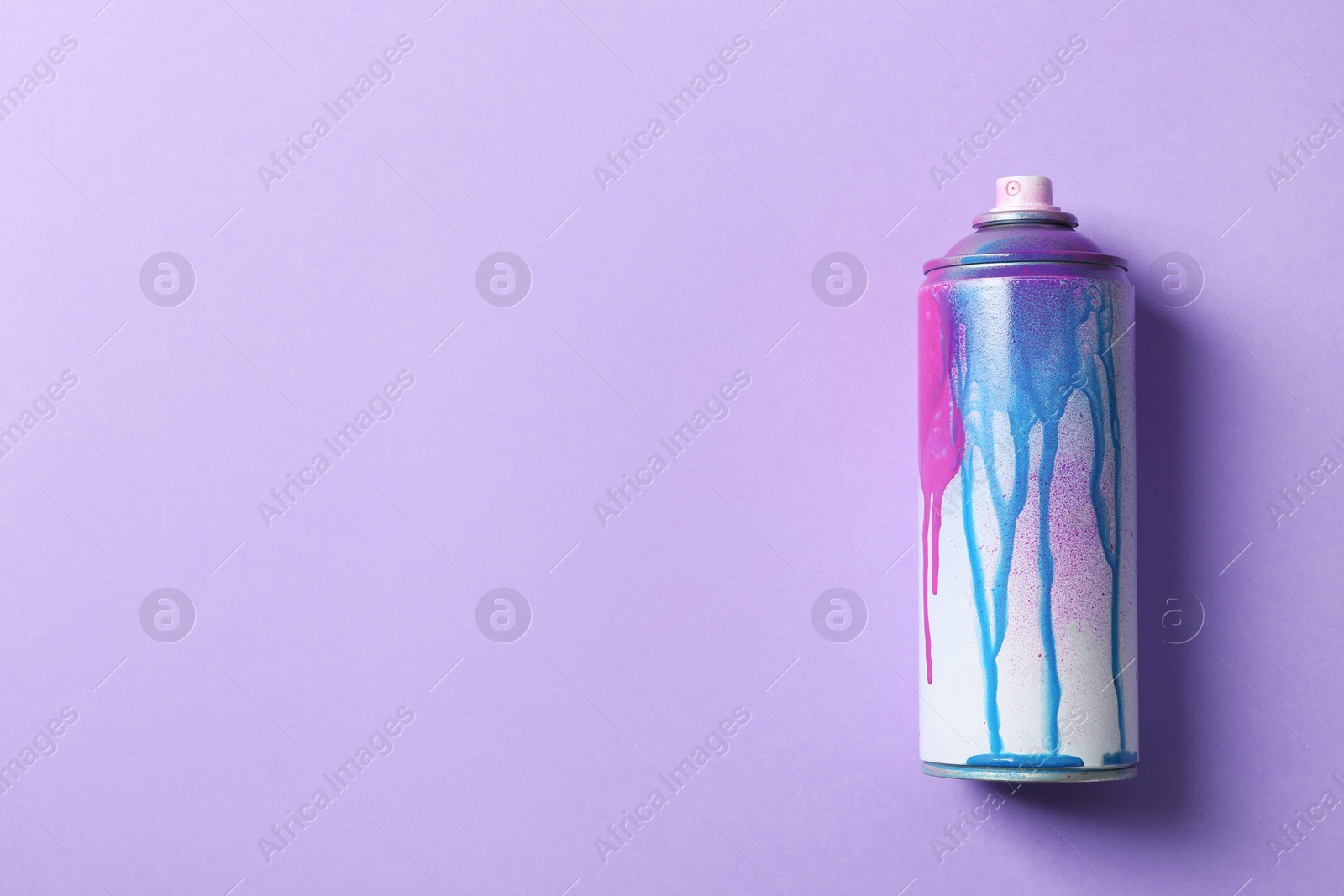 Photo of Used can of spray paint on color background, top view. Space for text