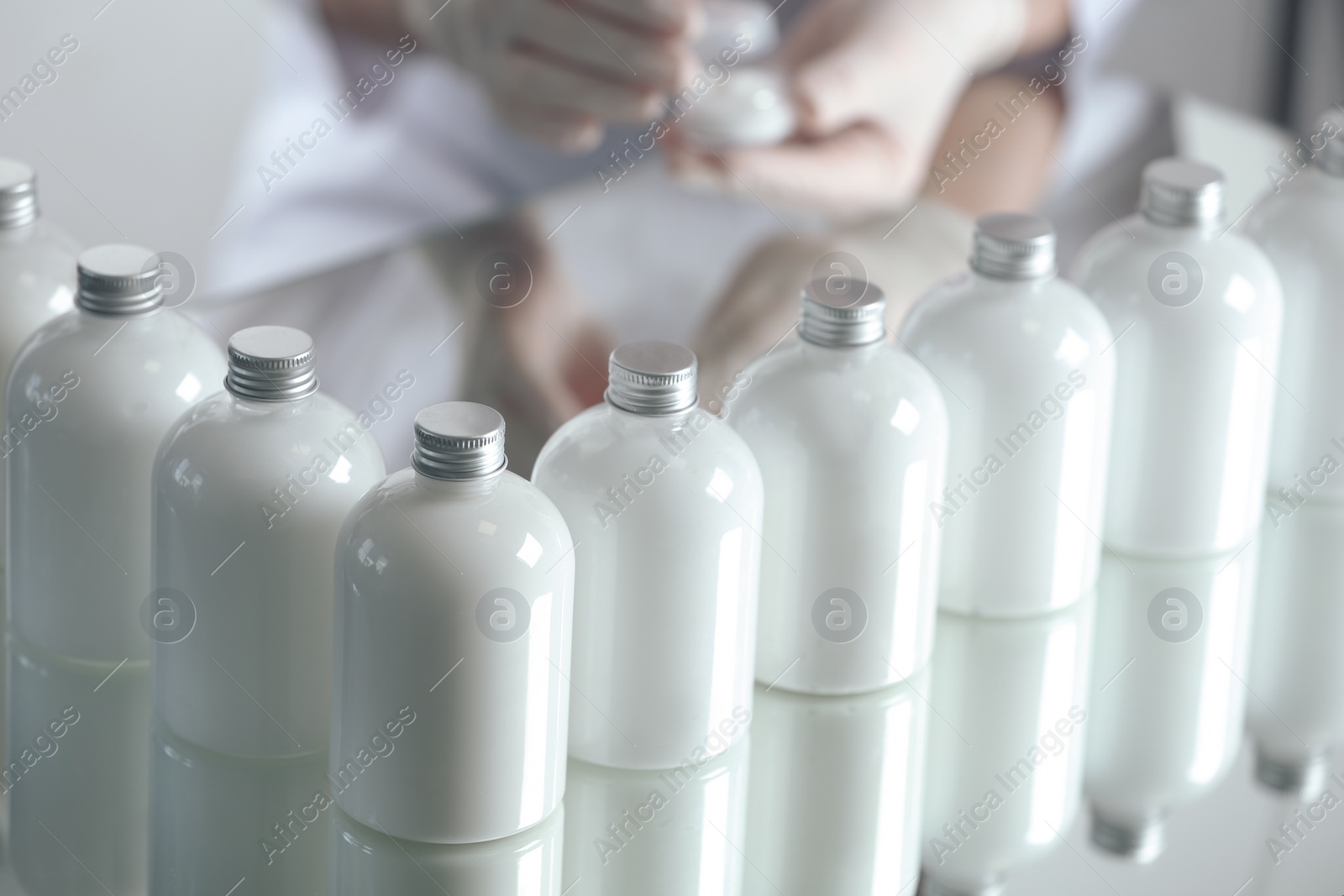 Photo of Many bottles with cosmetic product in laboratory