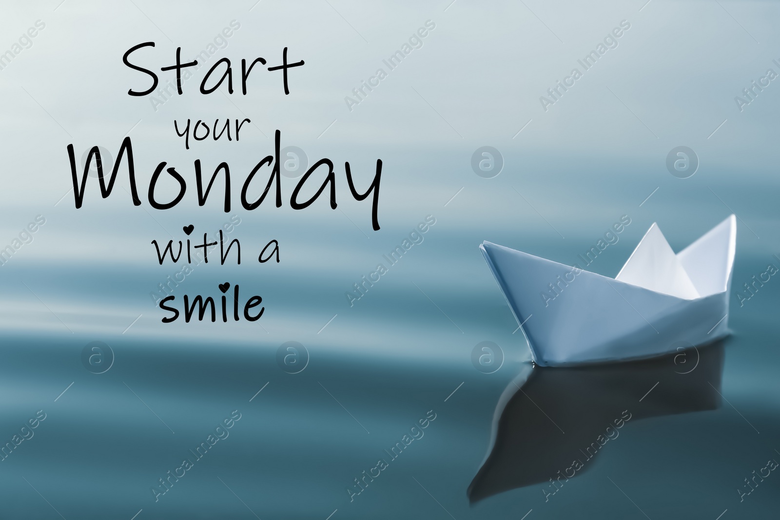 Image of Motivational quote Start your Monday with a Smile and white paper boat floating on river