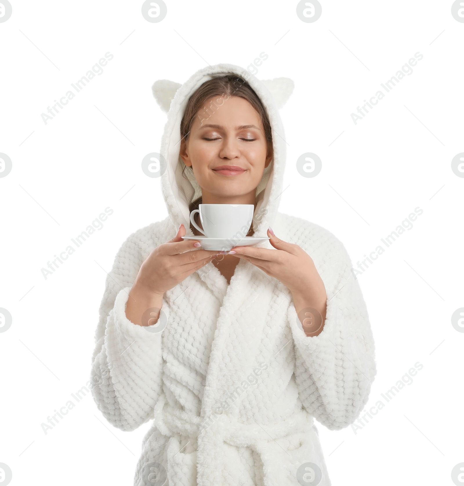 Photo of Young woman in bathrobe with cup of beverage on white background