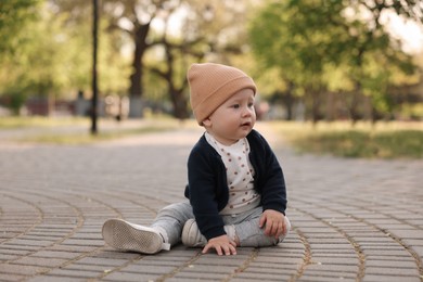 Photo of Portrait of little baby sitting in park