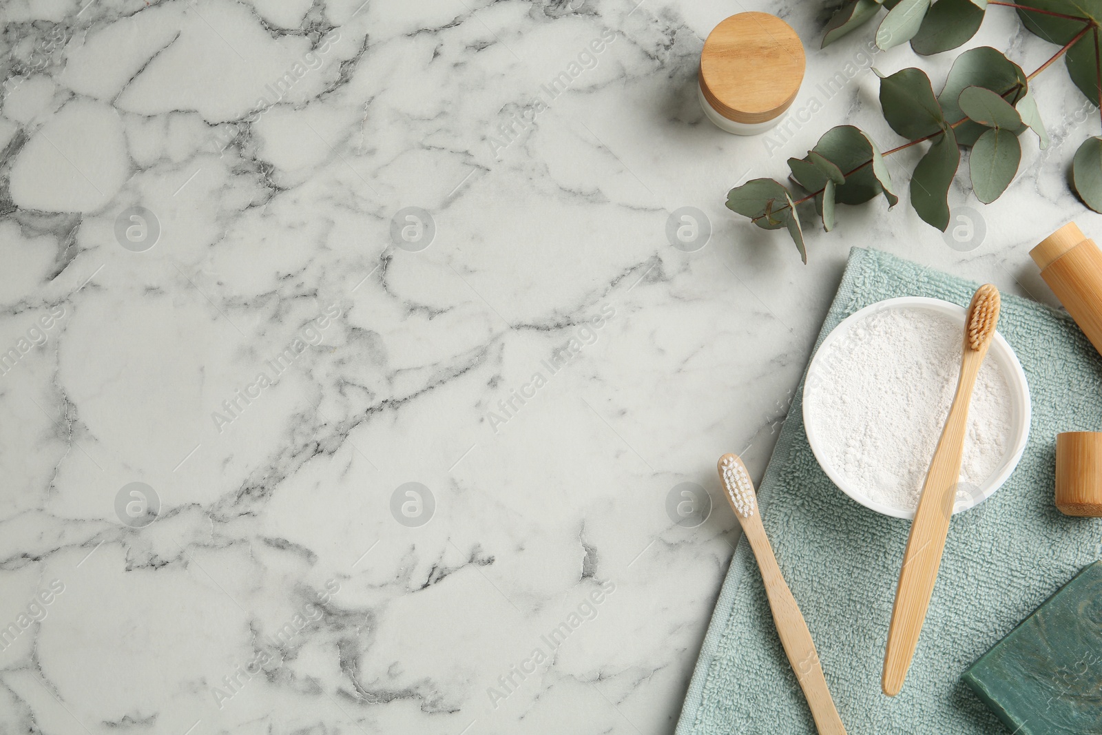 Photo of Flat lay composition with tooth powder and brushes on white marble table. Space for text