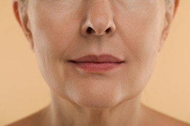 Photo of Woman with normal skin on beige background, macro view