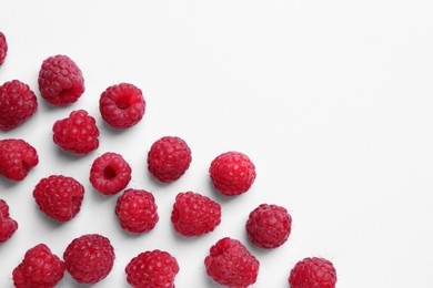 Photo of Tasty ripe raspberries on white background, flat lay. Space for text