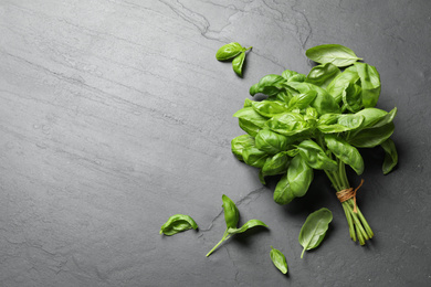 Photo of Fresh basil on grey table, flat lay. Space for text
