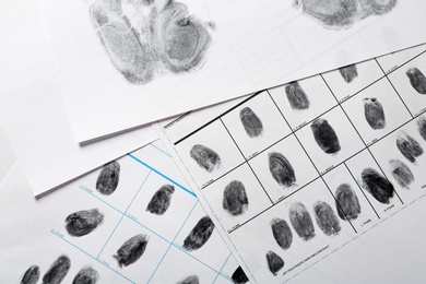 Police forms with fingerprints, top view. Forensic examination