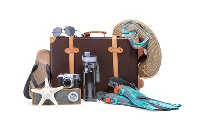 Suitcase, portable bluetooth speaker, vintage camera and different beach accessories isolated on white