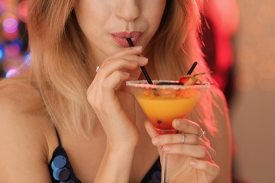 Photo of Young woman with glass of martini cocktail at party, closeup