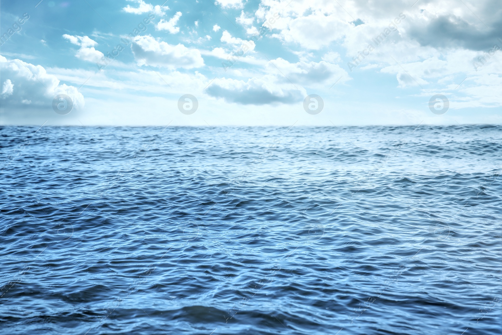 Image of Beautiful view of seascape and blue sky with white clouds on sunny day