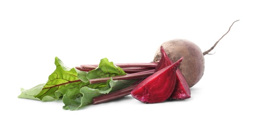 Whole and cut red beets on white background