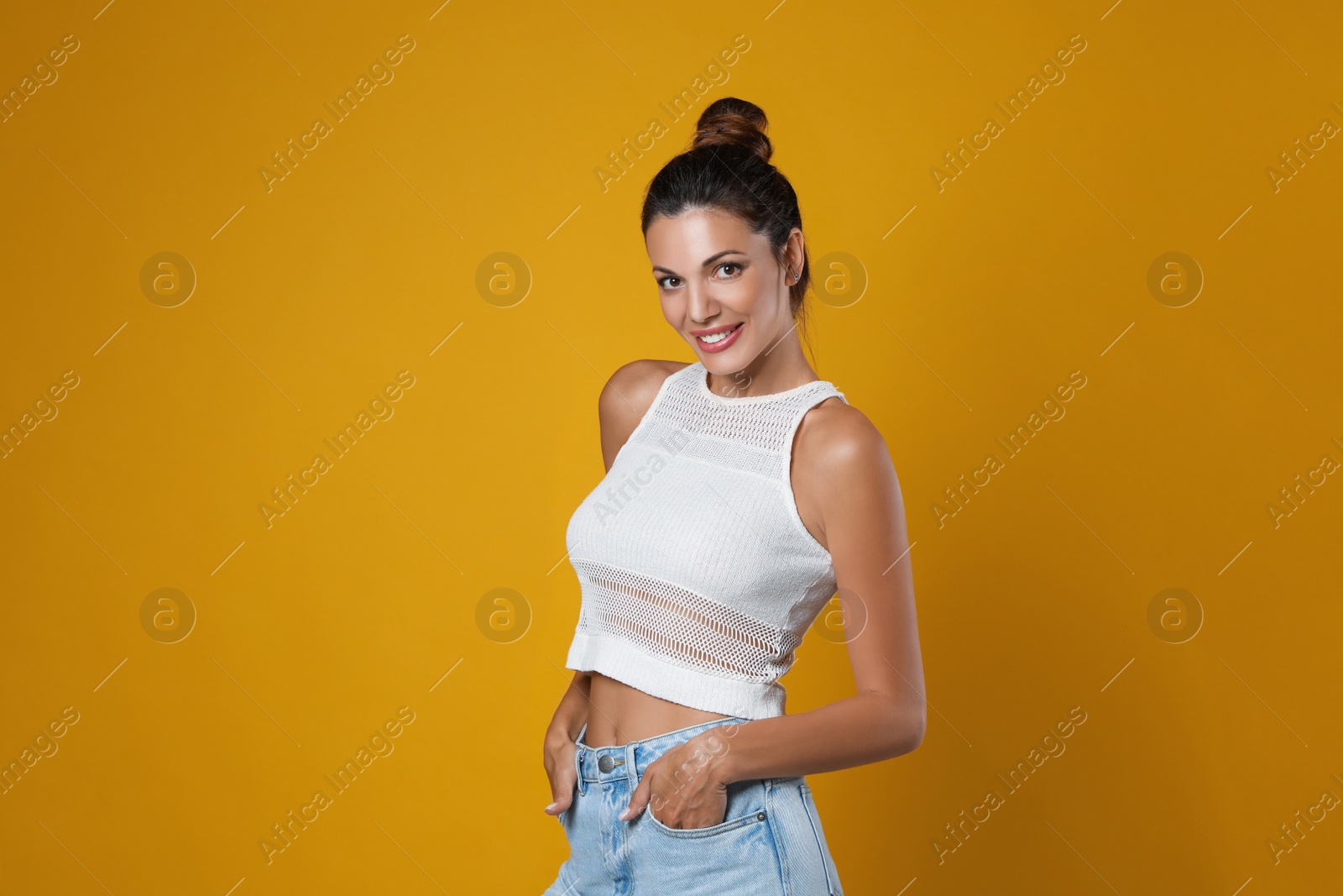 Photo of Portrait of beautiful woman on yellow background