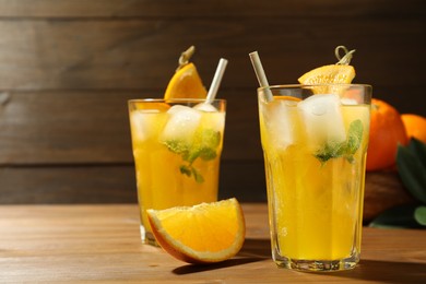 Photo of Delicious orange soda water on wooden table