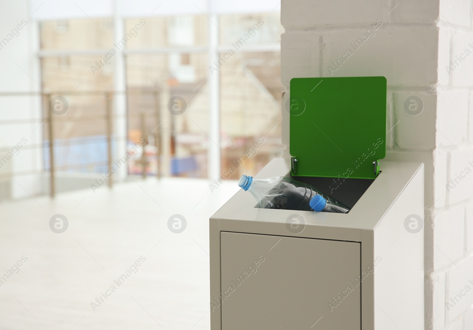 Photo of Metal bin with garbage indoors, space for text. Waste recycling