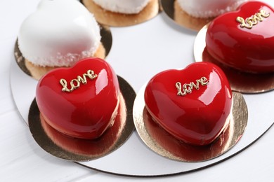 Photo of St. Valentine's Day. Delicious heart shaped cakes on white wooden table