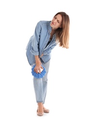 Woman applying cold compress to relieve knee pain on white background