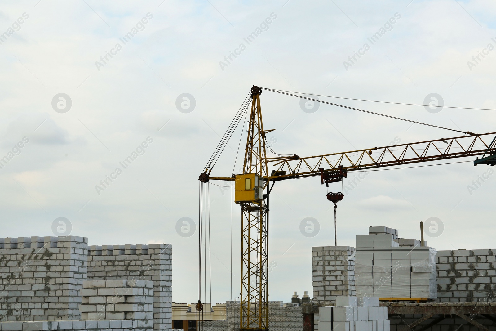 Photo of Construction site with tower crane near unfinished building