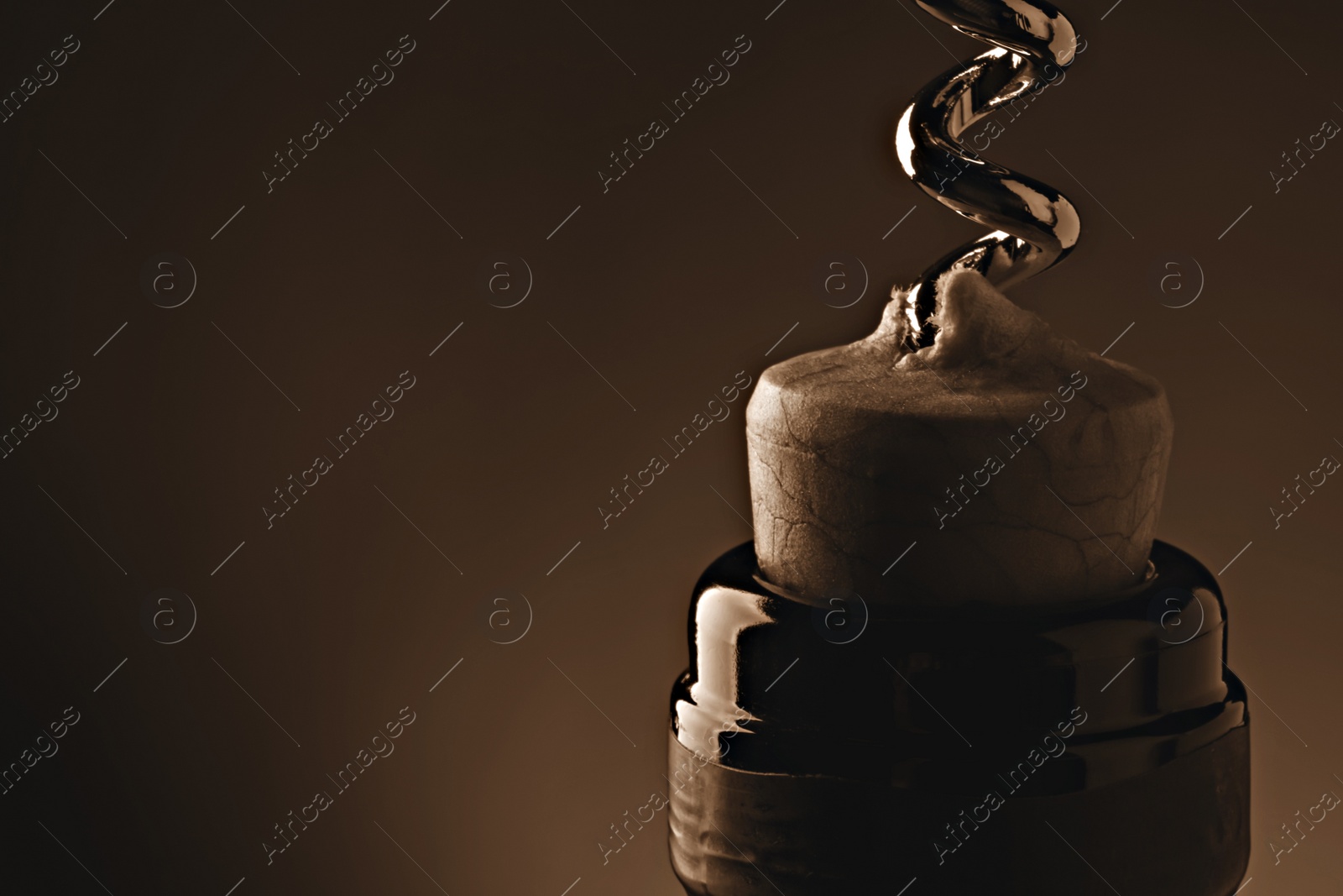 Image of Opening wine bottle with corkscrew on dark brown background, closeup. Space for text