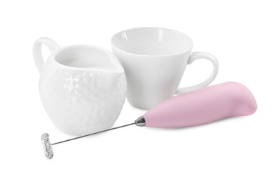 Photo of Milk frother wand, cup and pitcher isolated on white