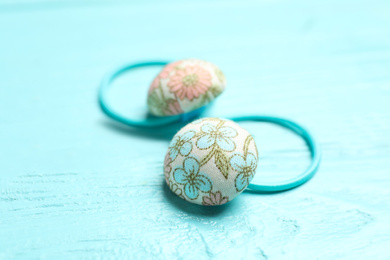 Cute hair scrunchies on light blue wooden table