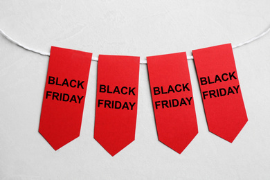 Photo of Word SALE made with red tags on light grey background, flat lay. Black Friday concept